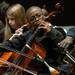 Scarlett Middle School eighth-grade cellist James Andrews, center, looks to director Mitchell Lawrence during Orchestra Night, which featured all five Ann Arbor middle school concert orchestras, along with performances from the Huron and Pioneer high school symphony orchestras.
LON HORWEDEL, THE ANN ARBOR NEWS
